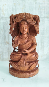 Reversible hand-carved wooden statue depicting a meditating Buddha on one side and an intricate Bodhi Tree design on the other, against a light background.
